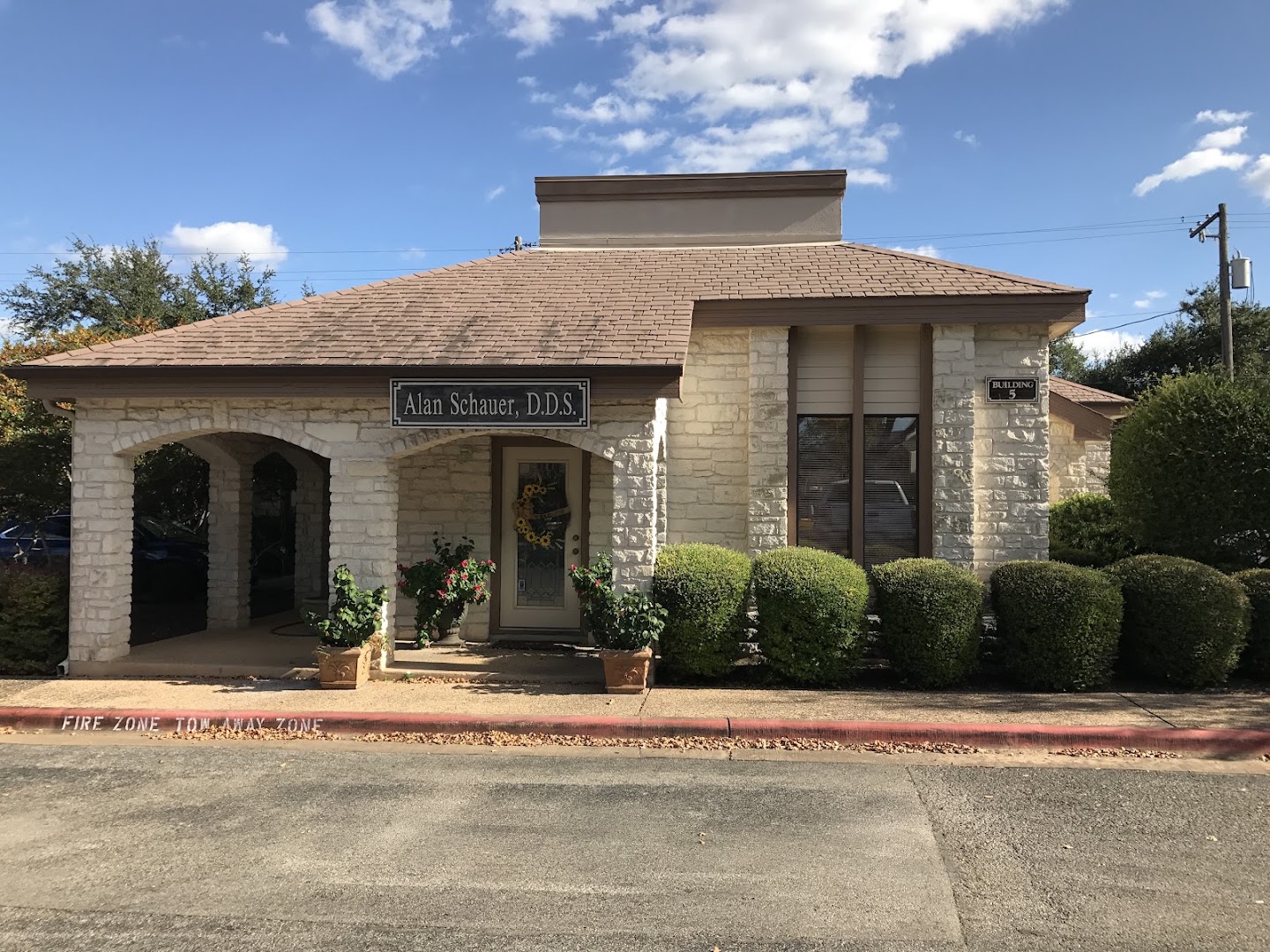 Stone exterior of Building 5 in the Hymeadow office park, home to Glauser Family Dentistry