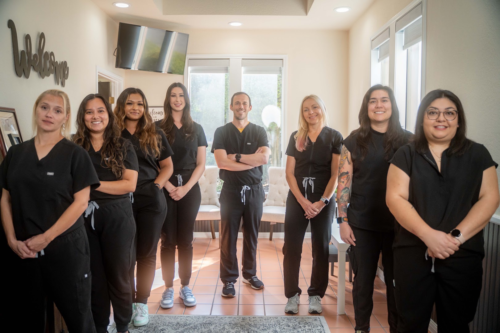 The Glauser Family Dentistry team standing together in the bright waiting area